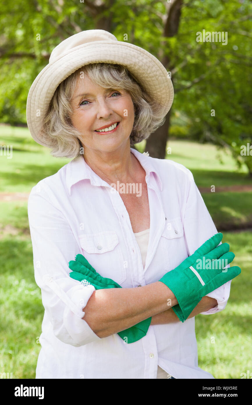 Woman standing in park crossed hi-res stock photography and images - Alamy