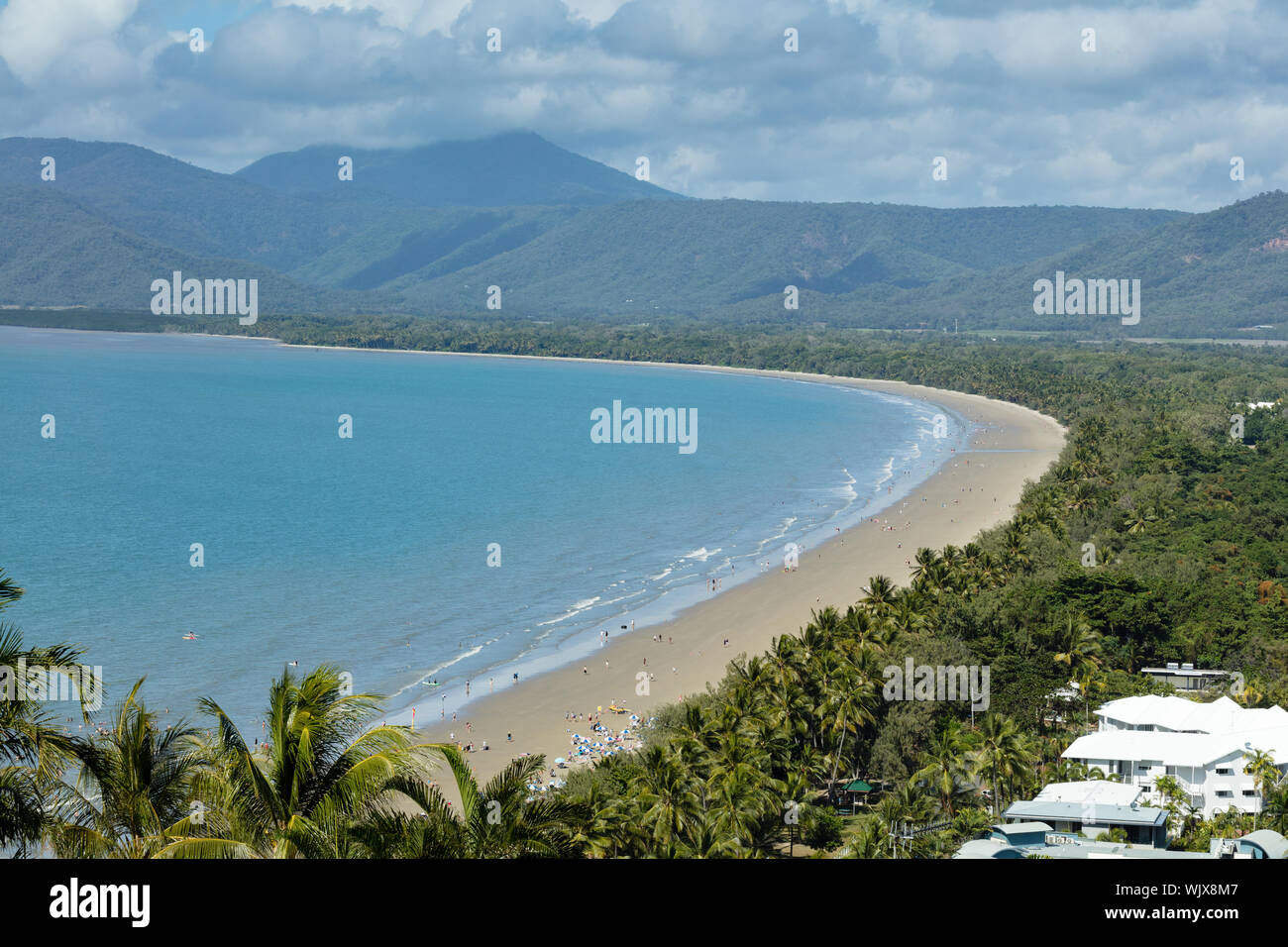 Port Douglas, Queensland, Australia. Four Mile Beach at Port Douglas with the dramatic backdrop of cloud covered mountains in tropical Far North Queen Stock Photo