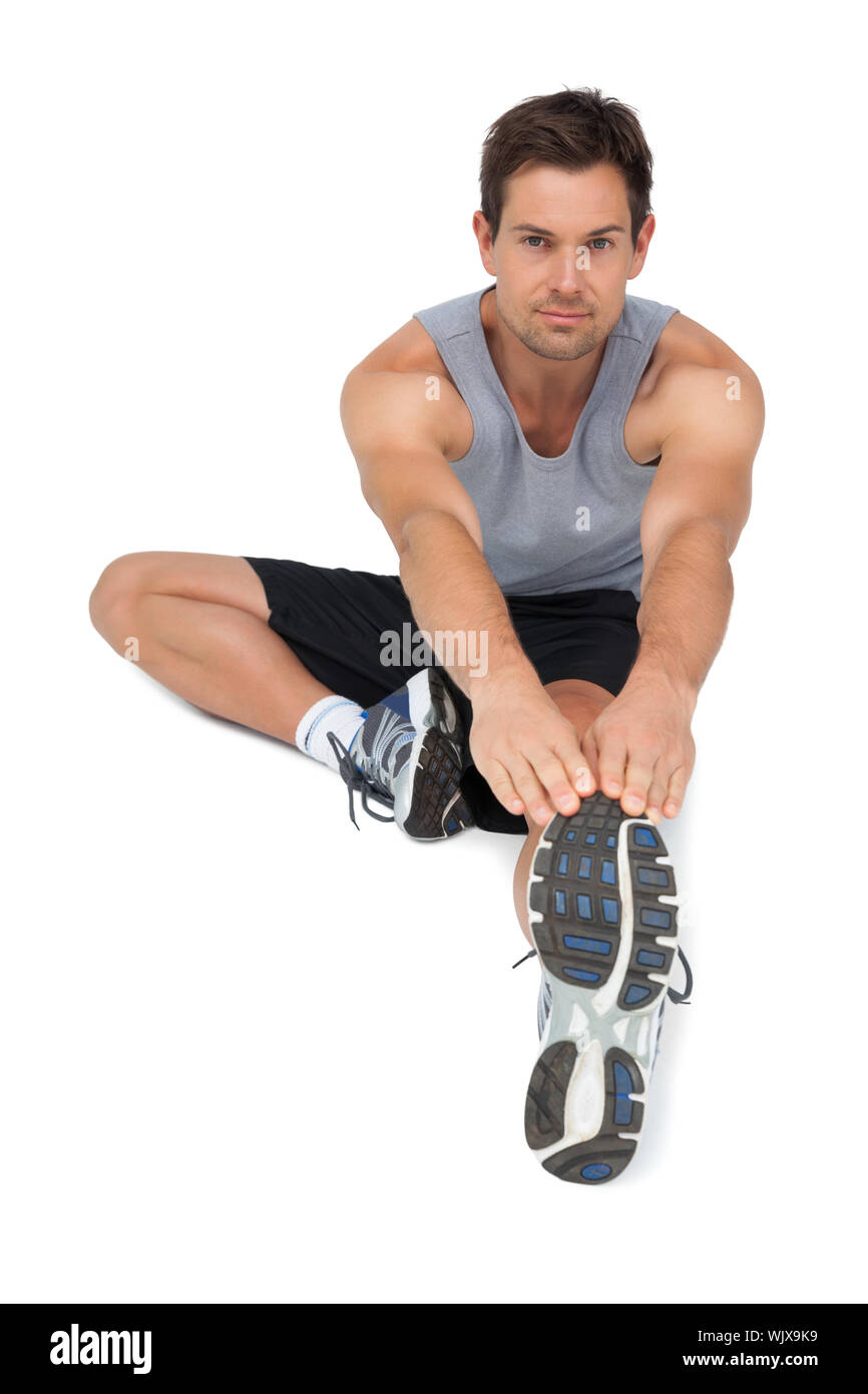 Muscular young man stretching Cut Out Stock Images & Pictures - Alamy