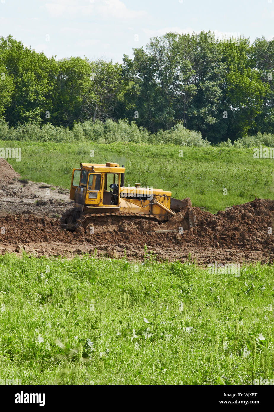 The old caterpillar tractor works in the fields Stock Photo Alamy