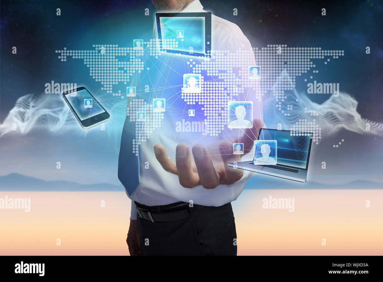 Digital composite of businessman presenting earth interface with connecting devices Stock Photo
