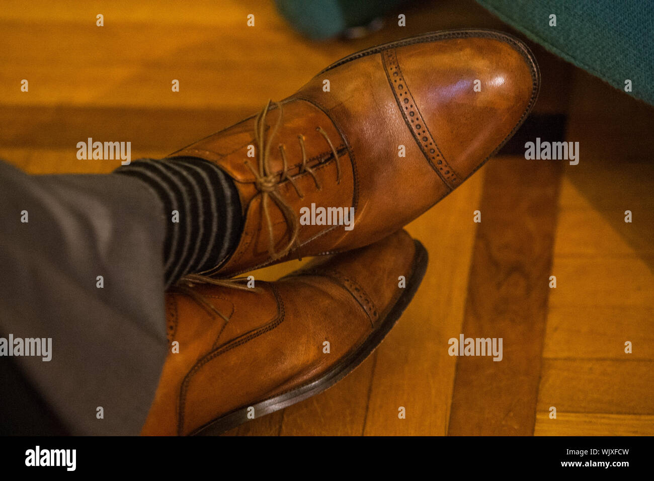 Low Section Of Man Wearing Brown Shoes On Floorboard Stock Photo Alamy