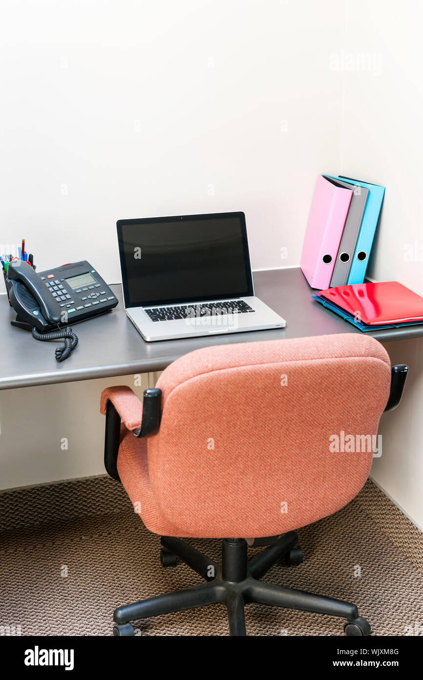 Workstation In Office With Swivel Chair Desk And Laptop Computer