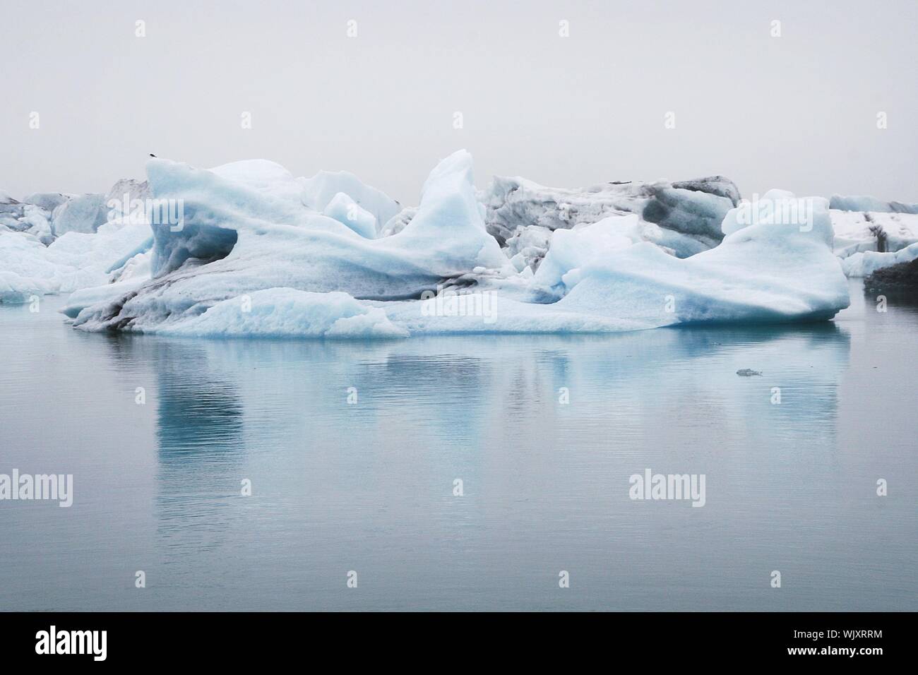 Beautiful shot of frozen icebergs near the shore of the sea Stock Photo