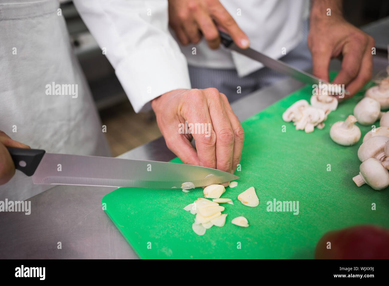 Two chefs preparing vegetables in a commercial kitchen Stock Photo Alamy