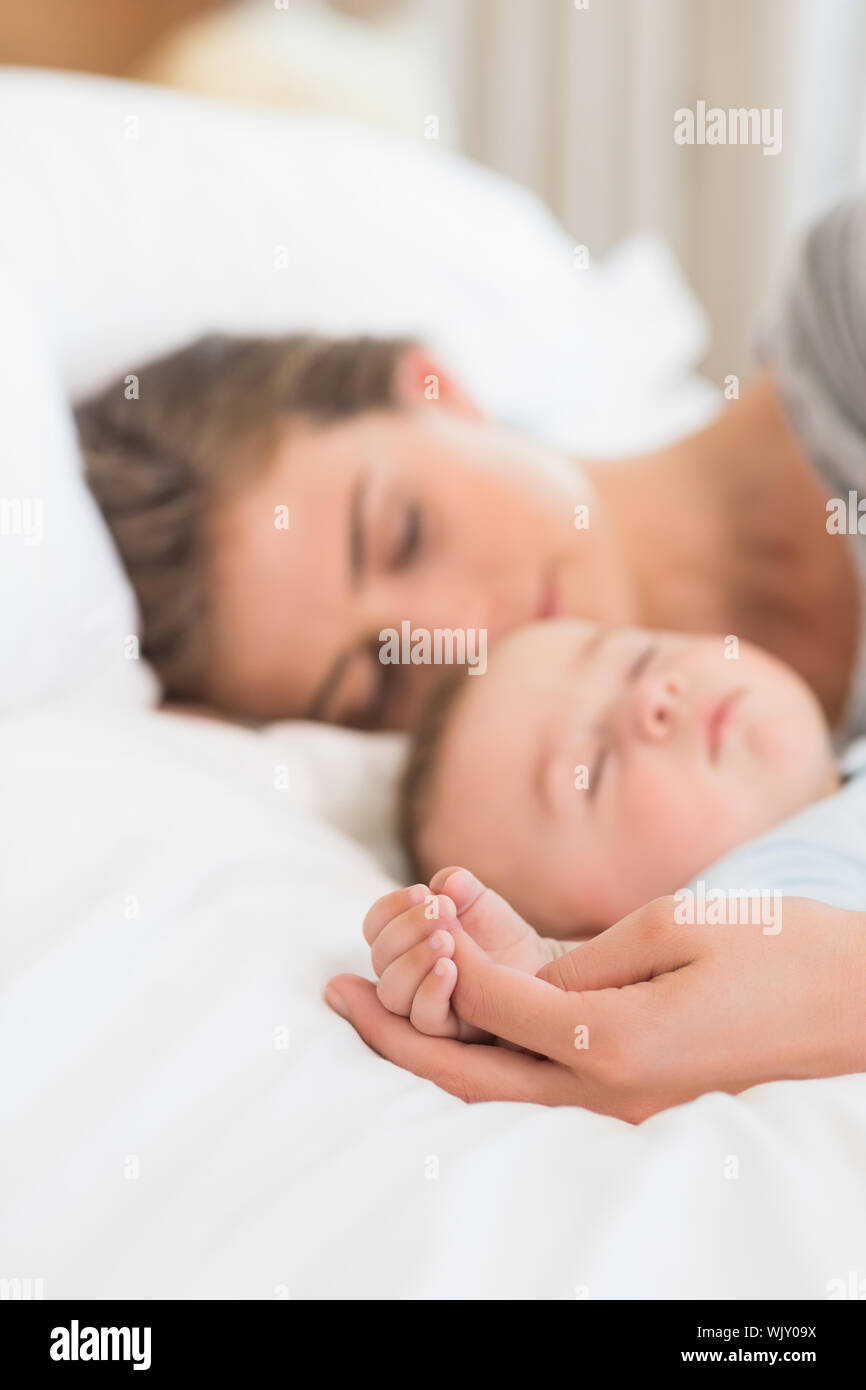 Mother sleeping with baby son on bed at home in bedroom Stock Photo Alamy