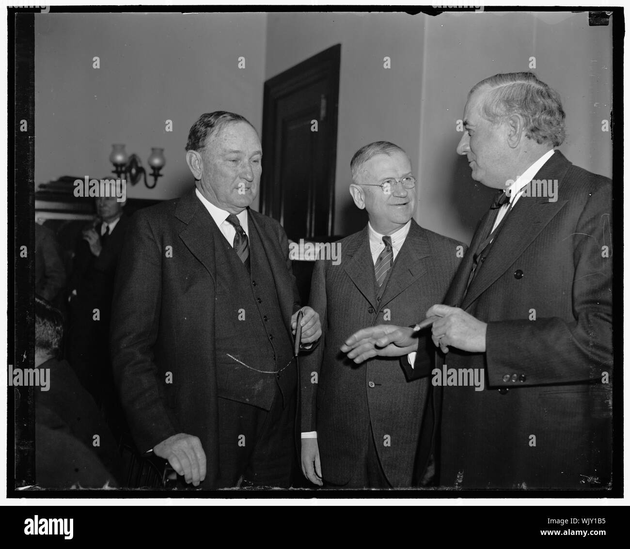 Ickes confers with Senators on Nat. Aud. Washington D.C. Secretary of the Interior Harold Ickes aAppeared before the Senate Public Buildings and Ground Committee today where Ickes presented a general plan for the new proposed National Auditorium so that there will not be a reccurance of the wet Inaguration day ceremonies. Left to right: Senator Joseph T. Robinson of Ark., Sec. Ickes, and Senator Tom Connally of Texas Stock Photo