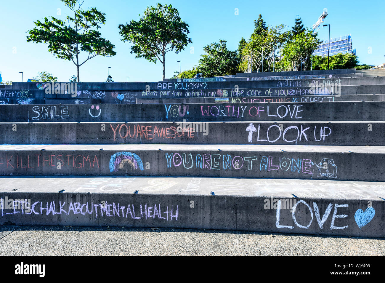 Slogans about mental wellbeing written in chalk on steps, Kangaroo Point Cliffs, Brisbane, Queensland, QLD, Australia Stock Photo