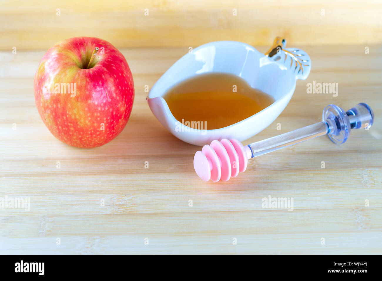 Honey and apples on wooden table background. Stock Photo