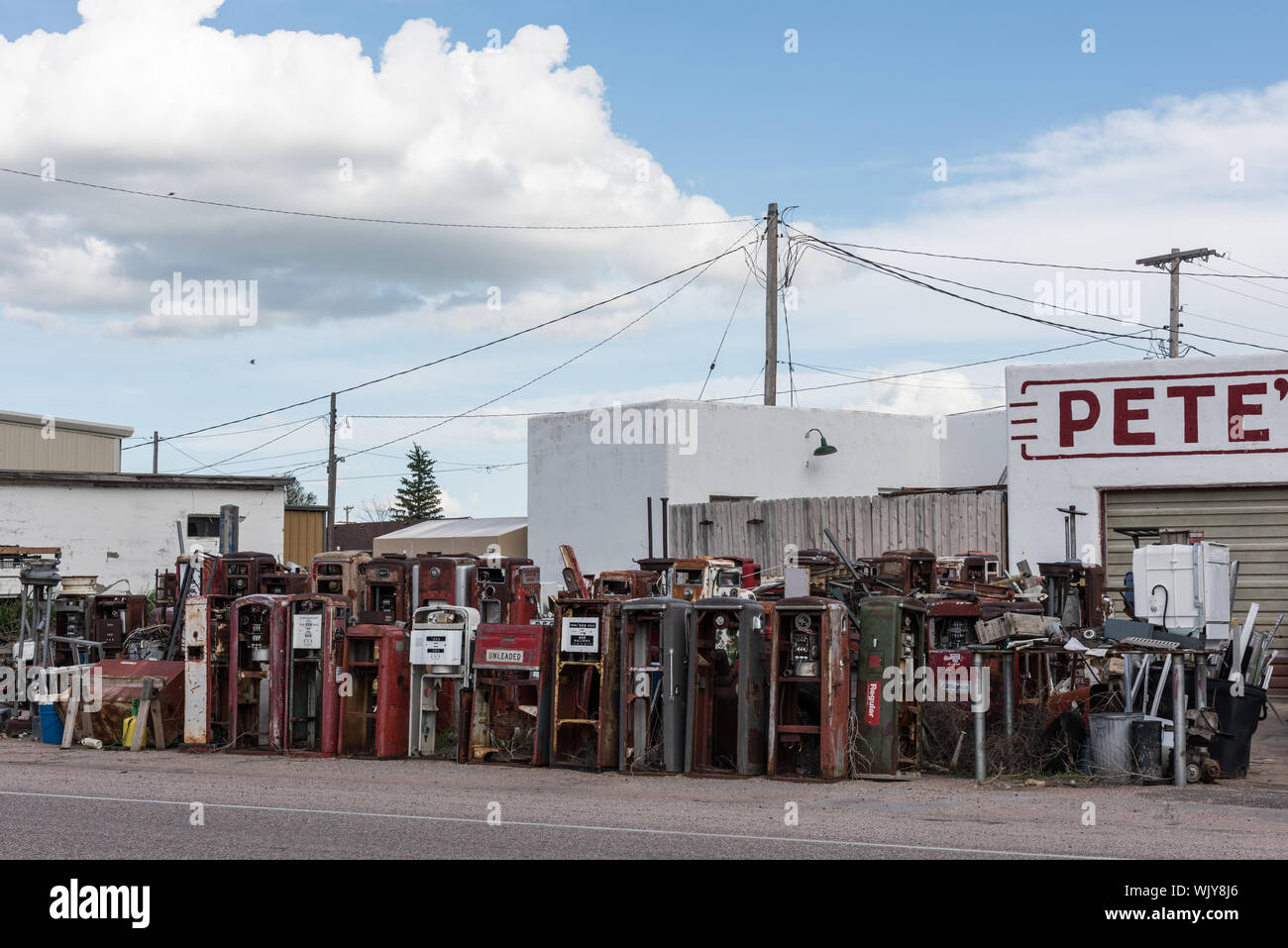 If you ever wondered where all the old gasoline pumps went when service stations closed or changed business purposes, some of them ended up at what was once an auto-service station, but became a second-hand store in Pine Bluffs, a small farming community on the Nebraska border in Laramie County, Wyoming Stock Photo