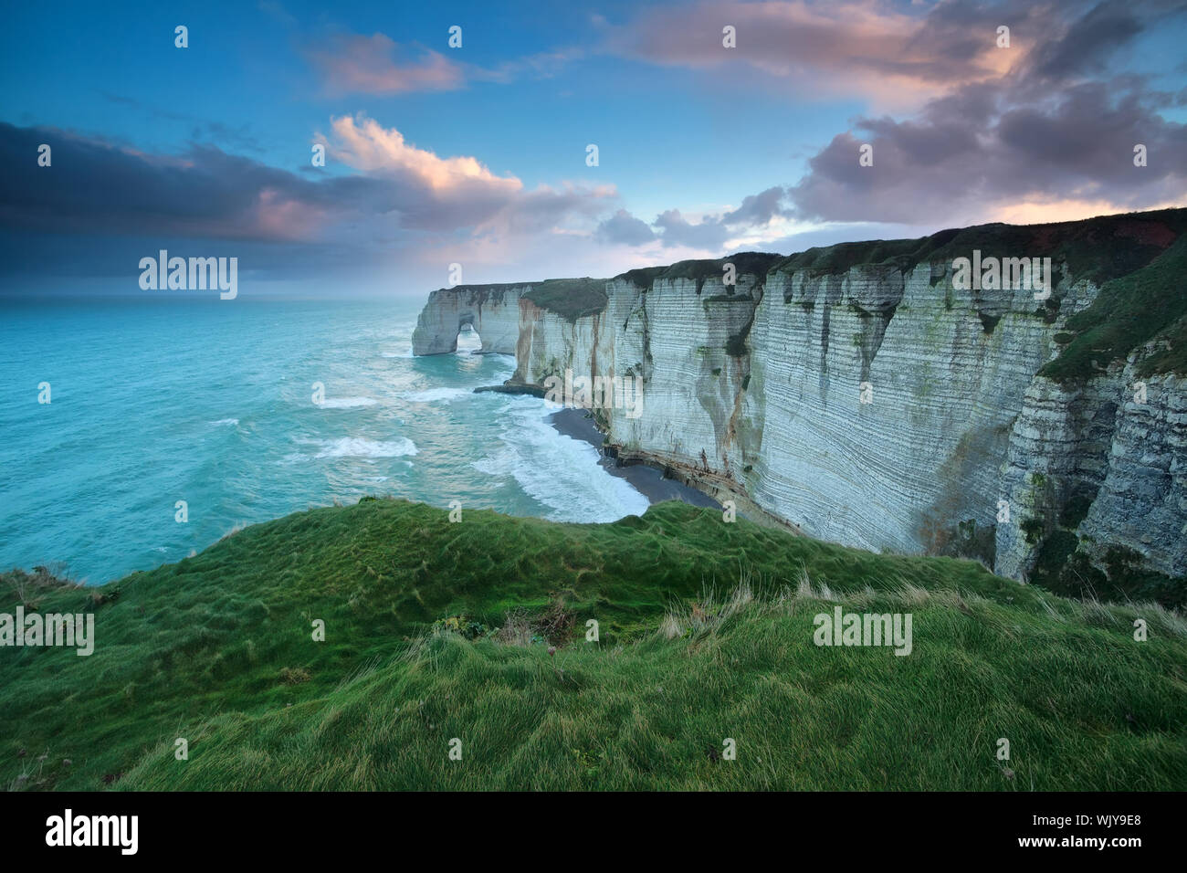 windy sunrise over cliff in Atlantic ocean, Etretat, Normandy, France ...