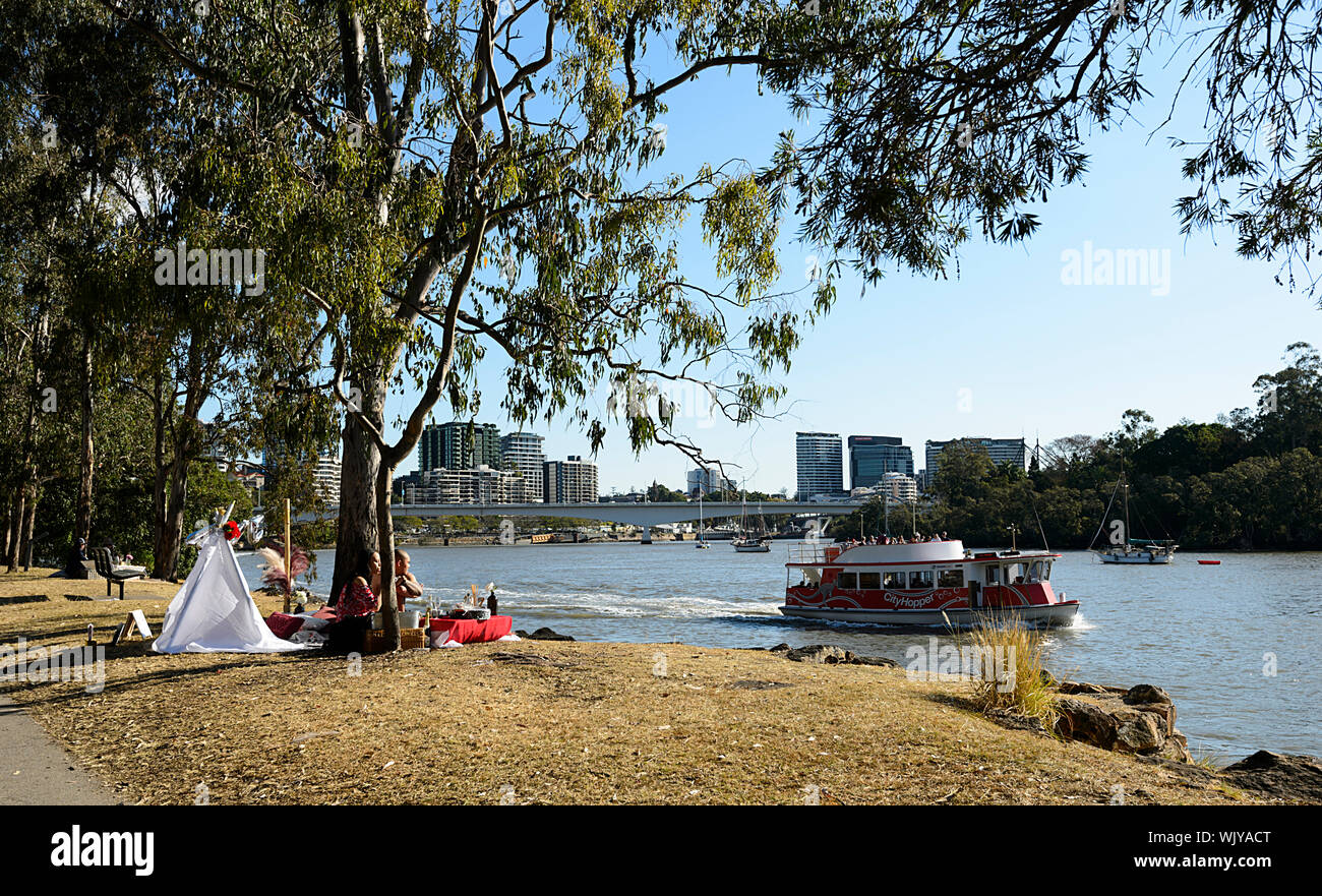 Couple having a romantic picnic along the Brisbane River at Kangaroo