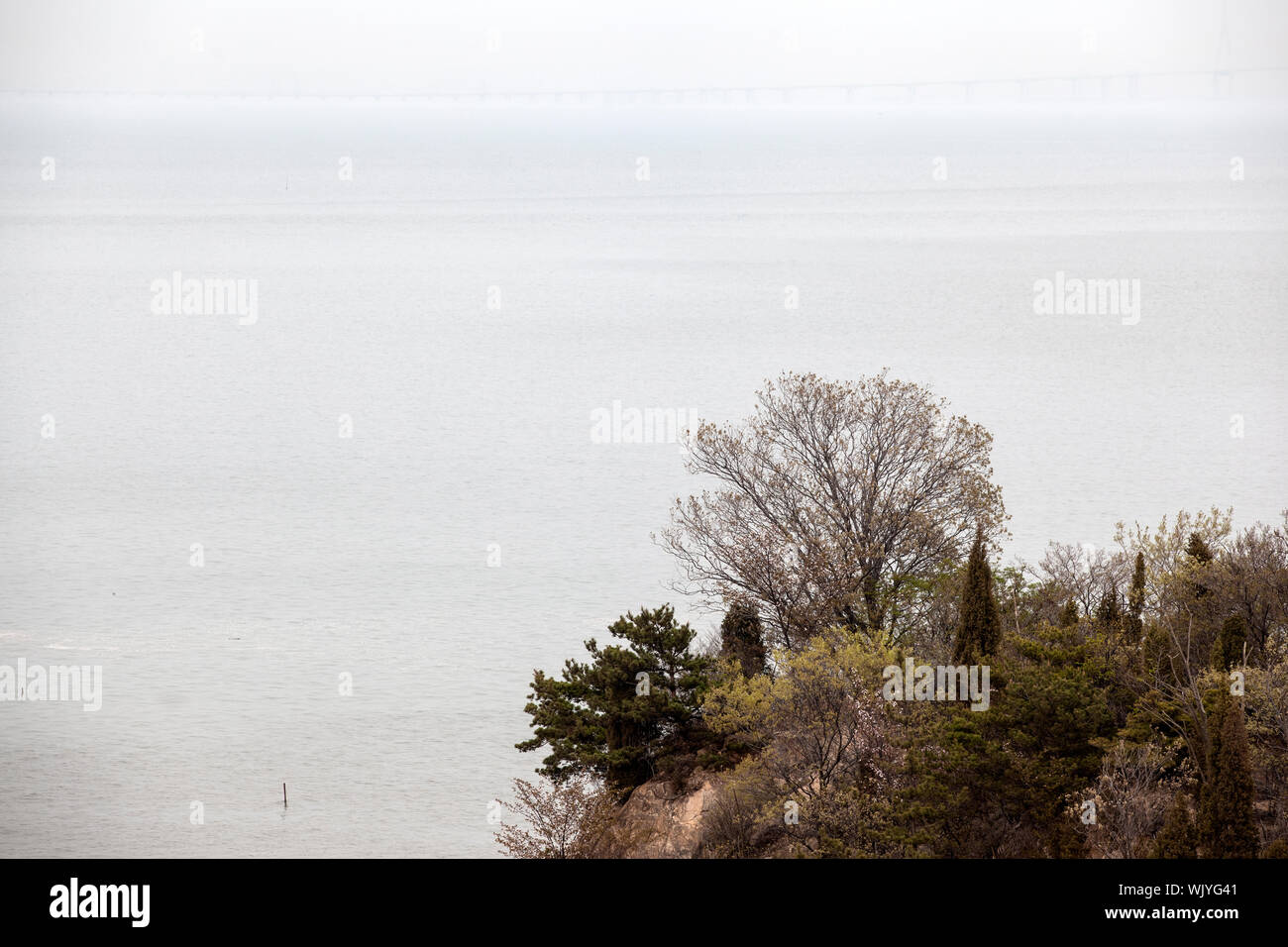 View Of Overcast Sky Blending Into Seascape In Autumn Stock Photo
