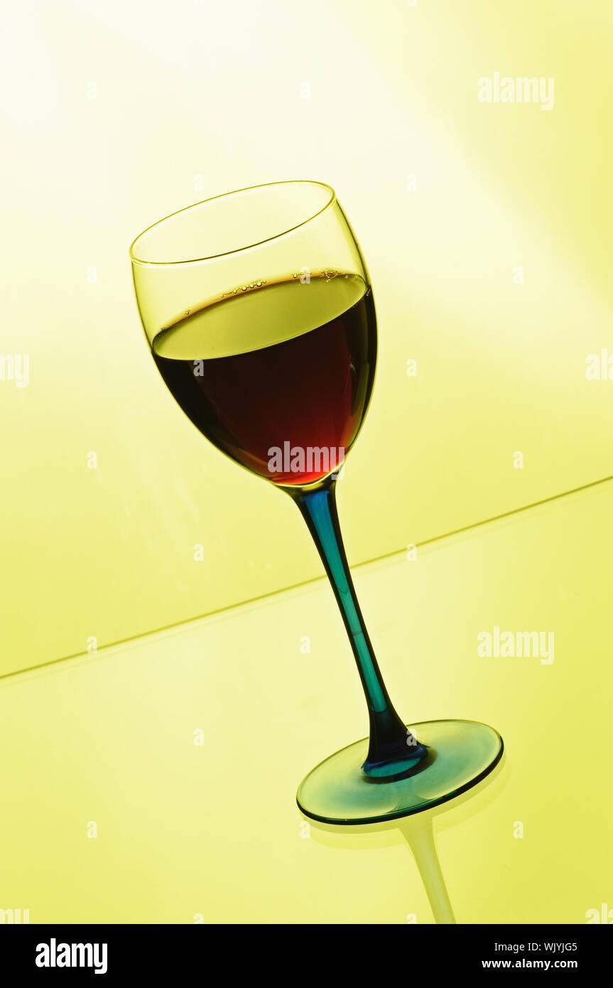 Download Wineglass With Red Wine On Yellow Background Stock Photo Alamy Yellowimages Mockups