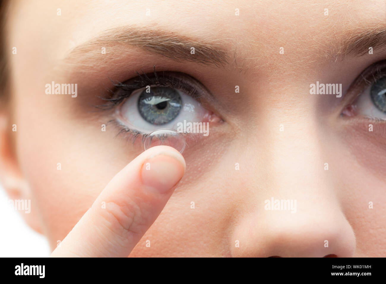 Extreme close up on gorgeous model applying contact lens Stock Photo