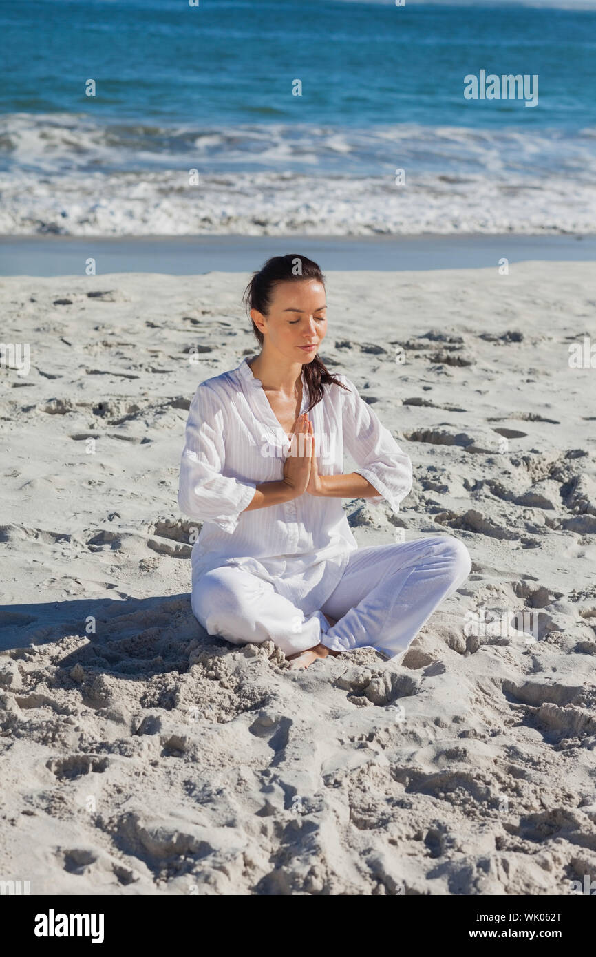 Calm Slim Woman Practicing Yoga Meditating Enjoying Training Beach Sea  Stock Photo by ©Milkos 654544574