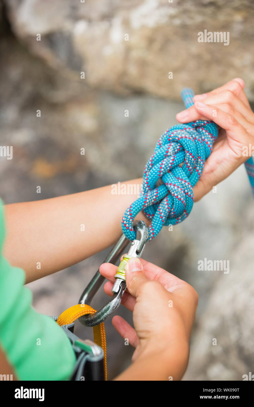 Female rock climber adjusting her harness Stock Photo