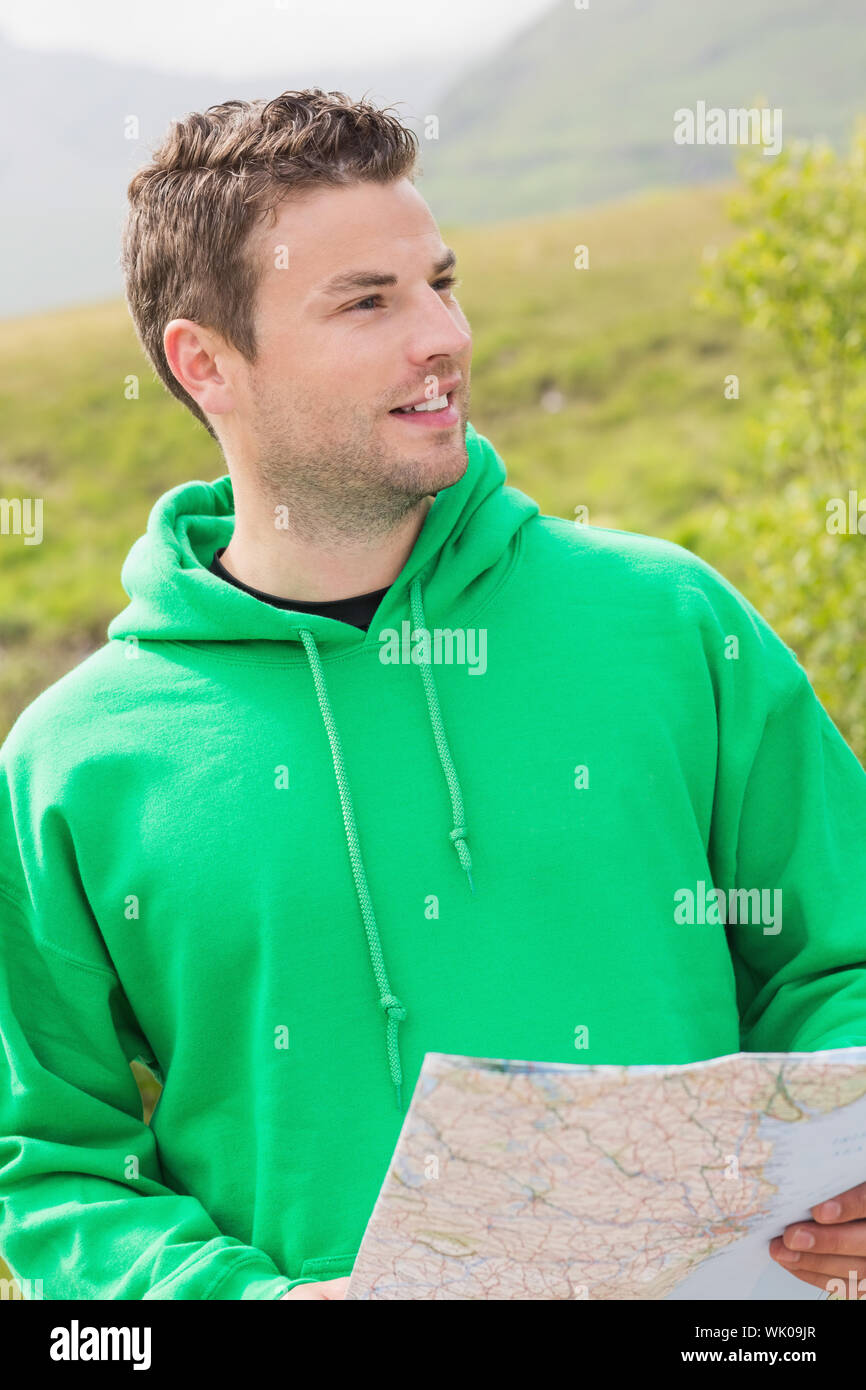 Athletic man holding a map and looking ahead Stock Photo