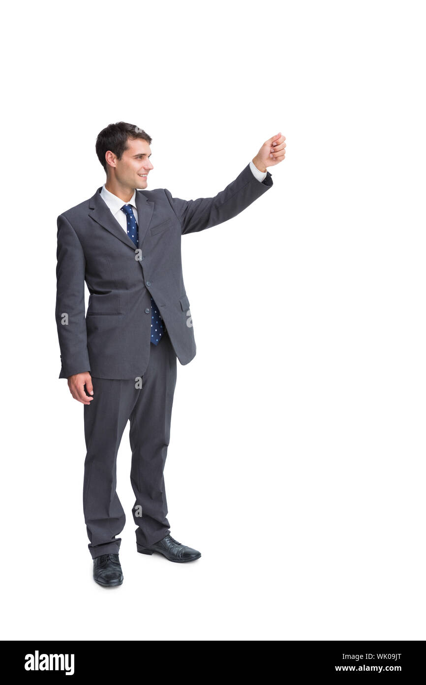 Smiling businessman holding something up in the air Stock Photo