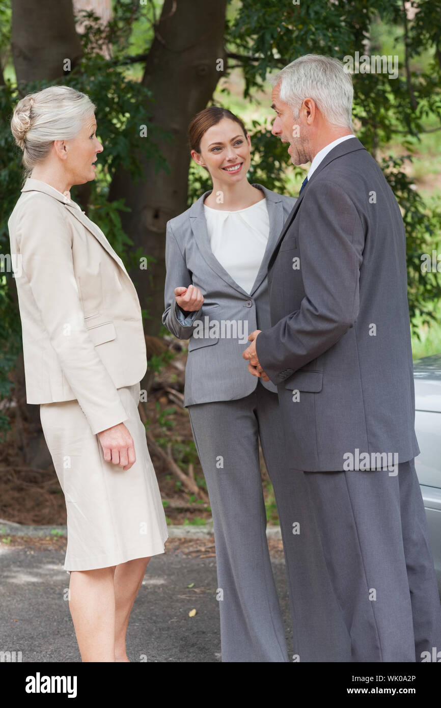 Smiling business people talking together Stock Photo