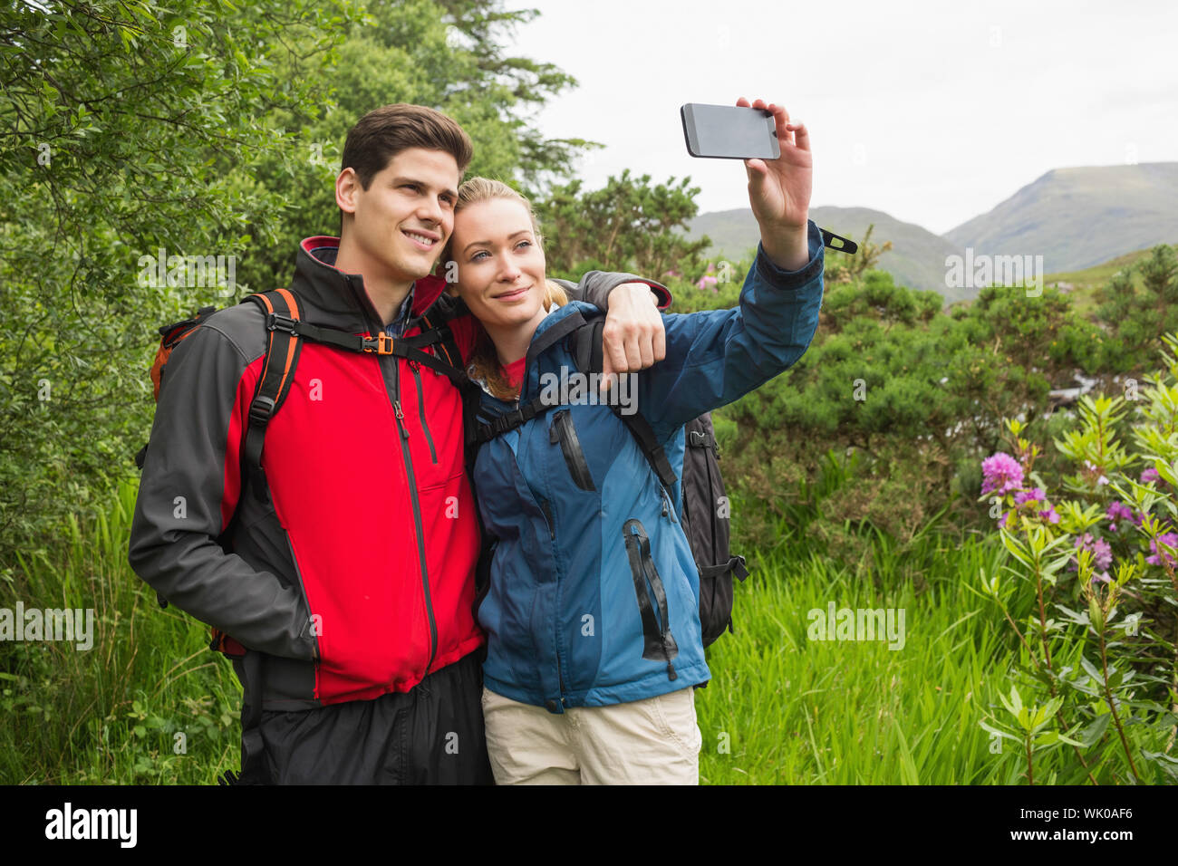 Happy couple on hike taking a selfie Stock Photo