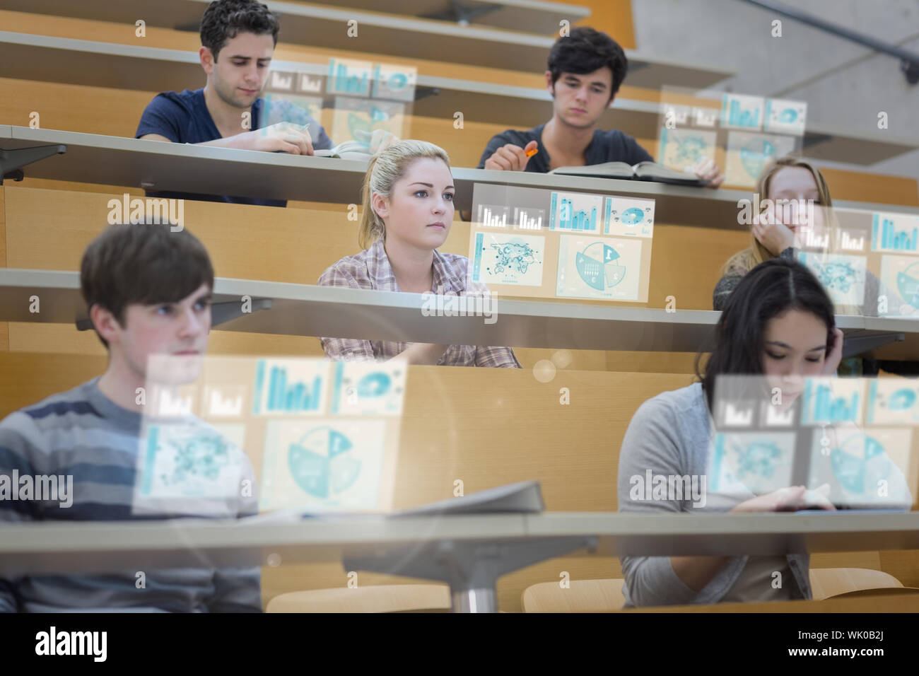 Focused students in lecture hall working on their futuristic tablet Stock Photo