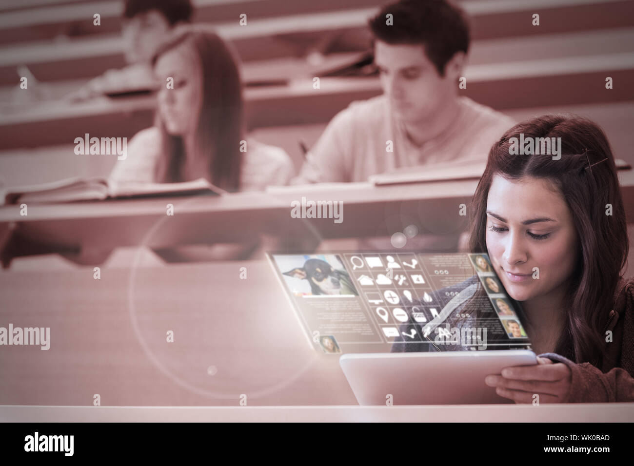 Student using tablet pc to take notes in lecture hall Stock Photo