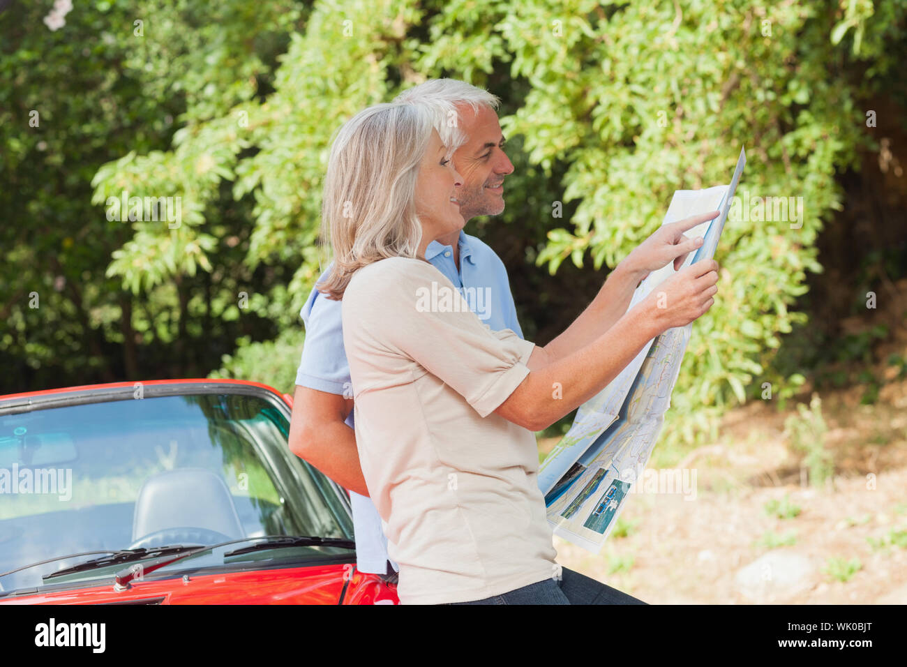Smiling mature couple reading map together Stock Photo