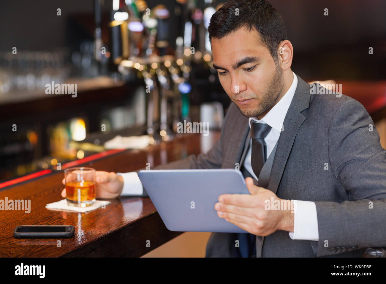 Serious businessman working on his tablet computer Stock Photo