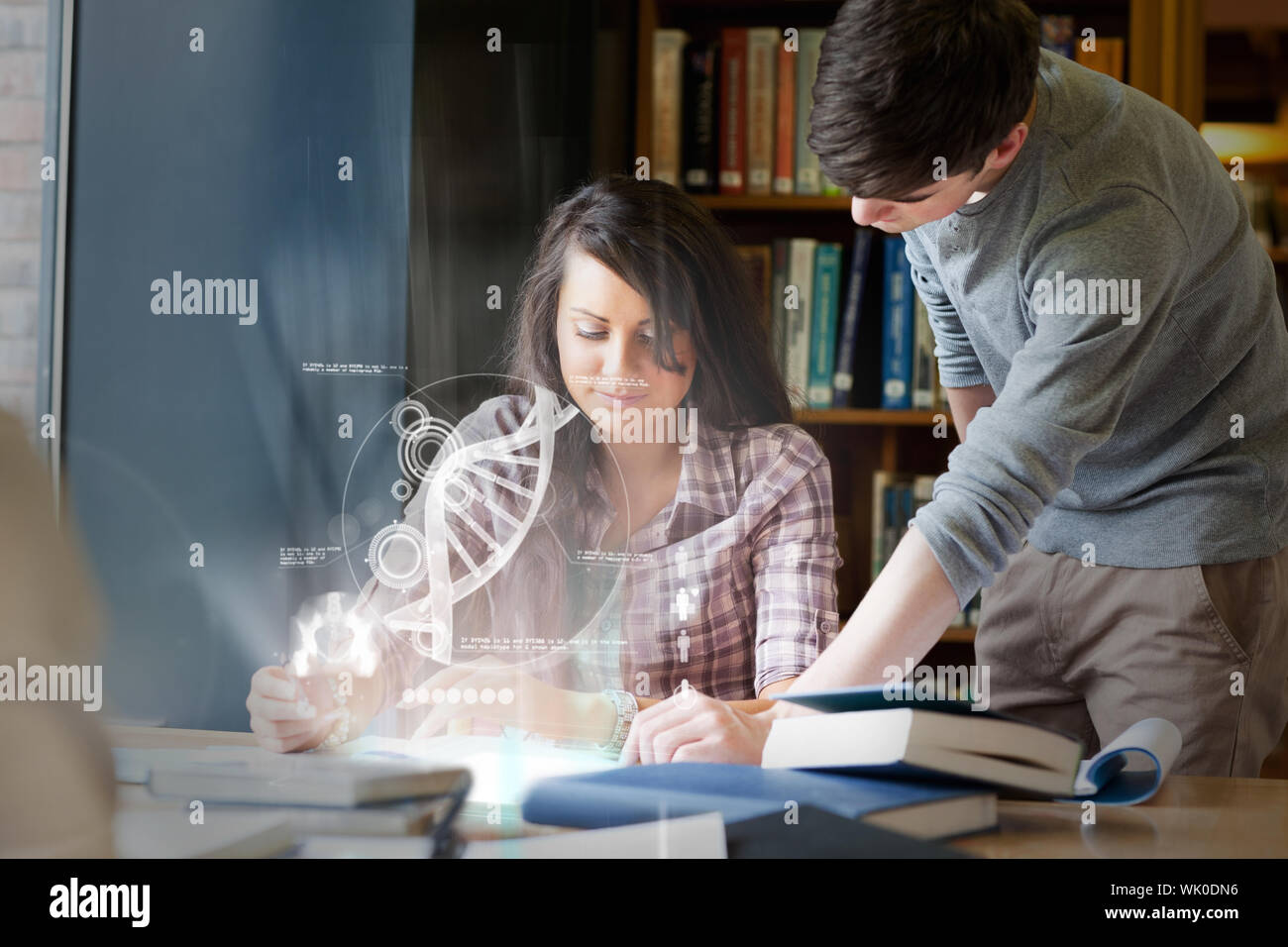 Concentrated college students analysing dna on digital interface Stock Photo