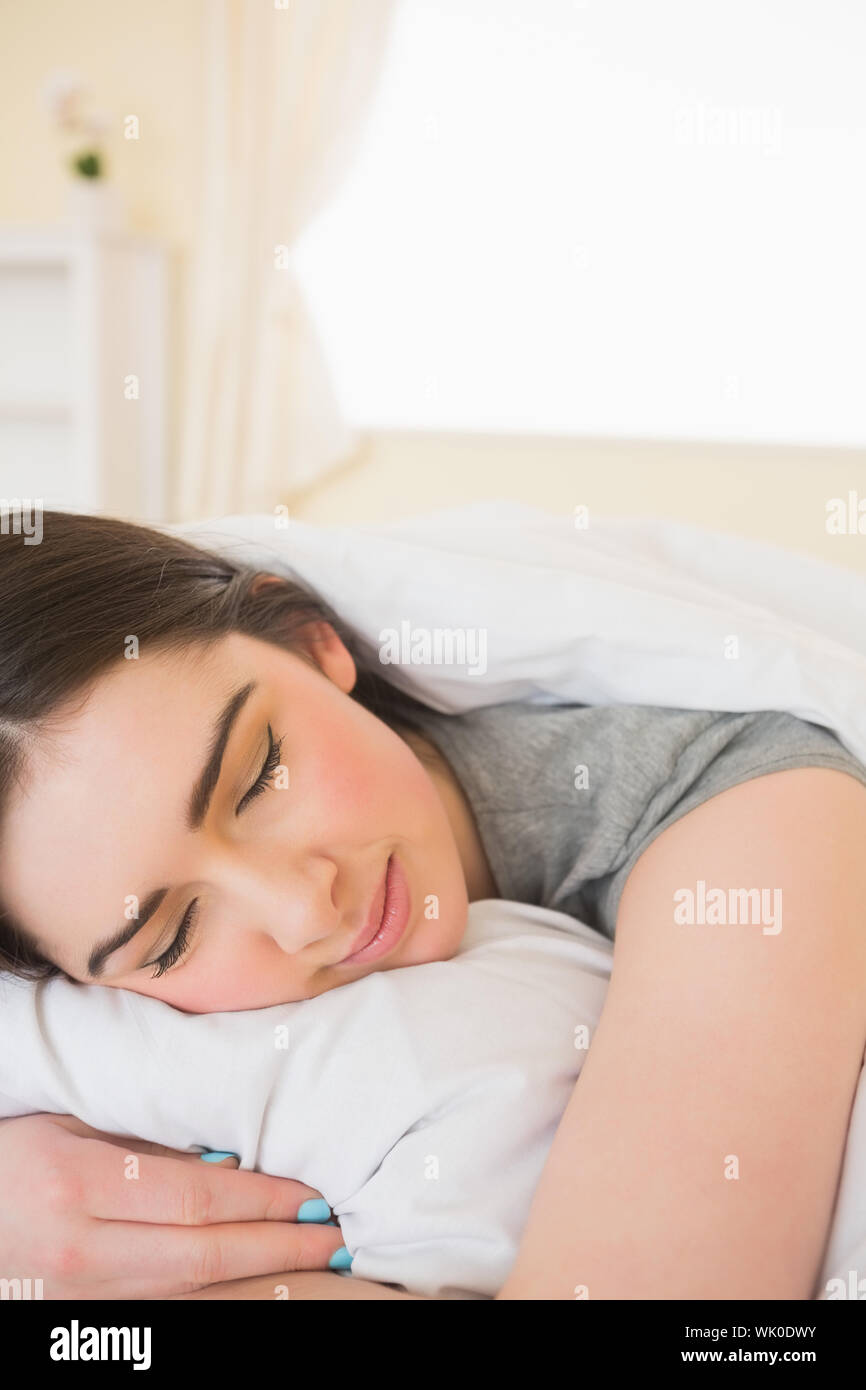 Smiling girl sleeping in her bed Stock Photo - Alamy