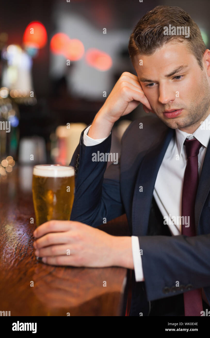 Pensive businessman having a drink Stock Photo