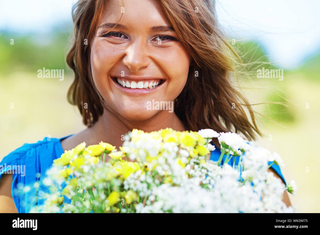 Portrait of young beautiful girl holding bouquet of flowers Stock Photo ...