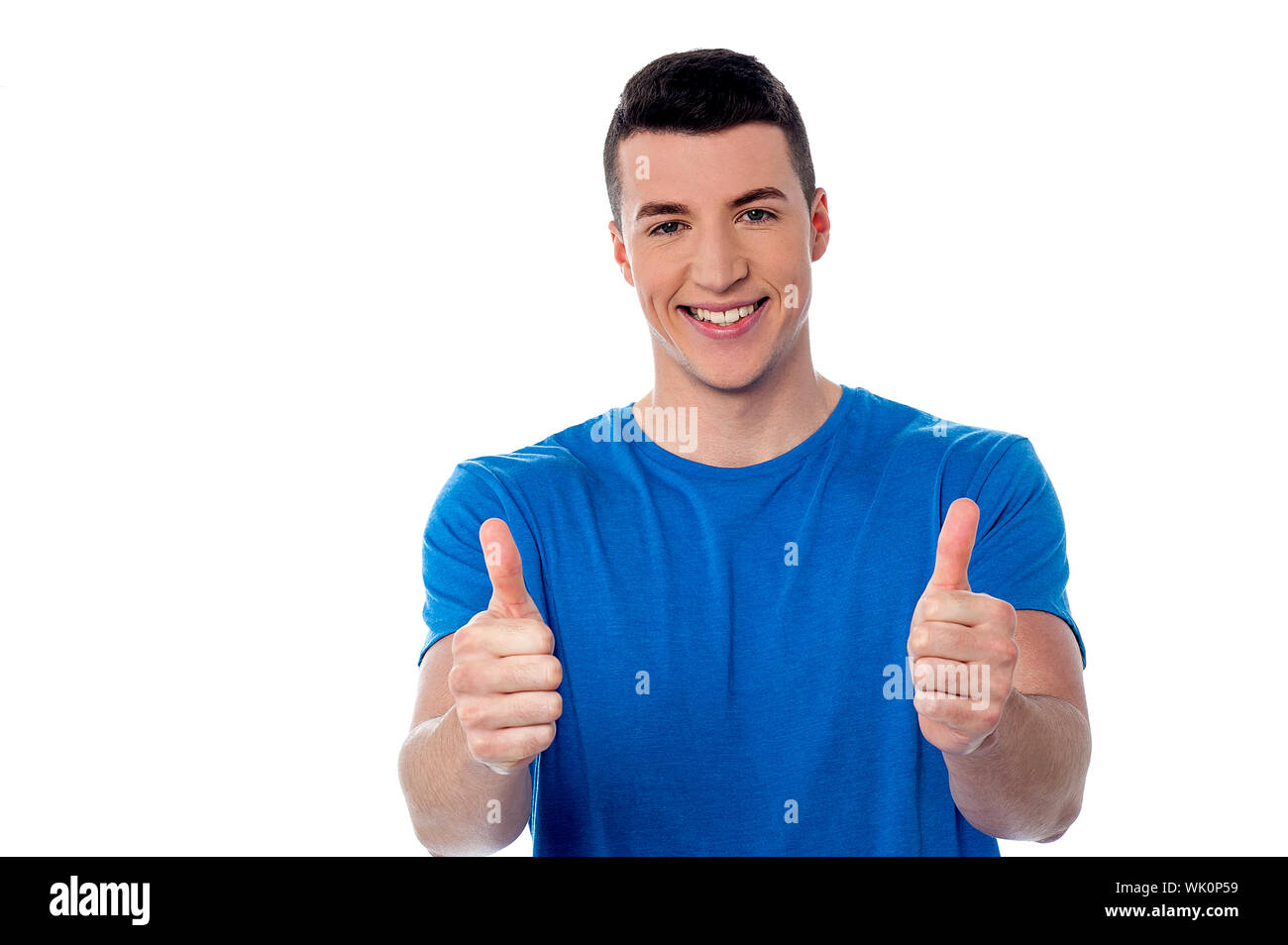 Successful young man showing double thumbs up Stock Photo Alamy