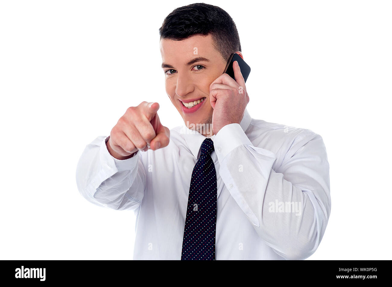 Businessman communicating through mobile and pointing you Stock Photo