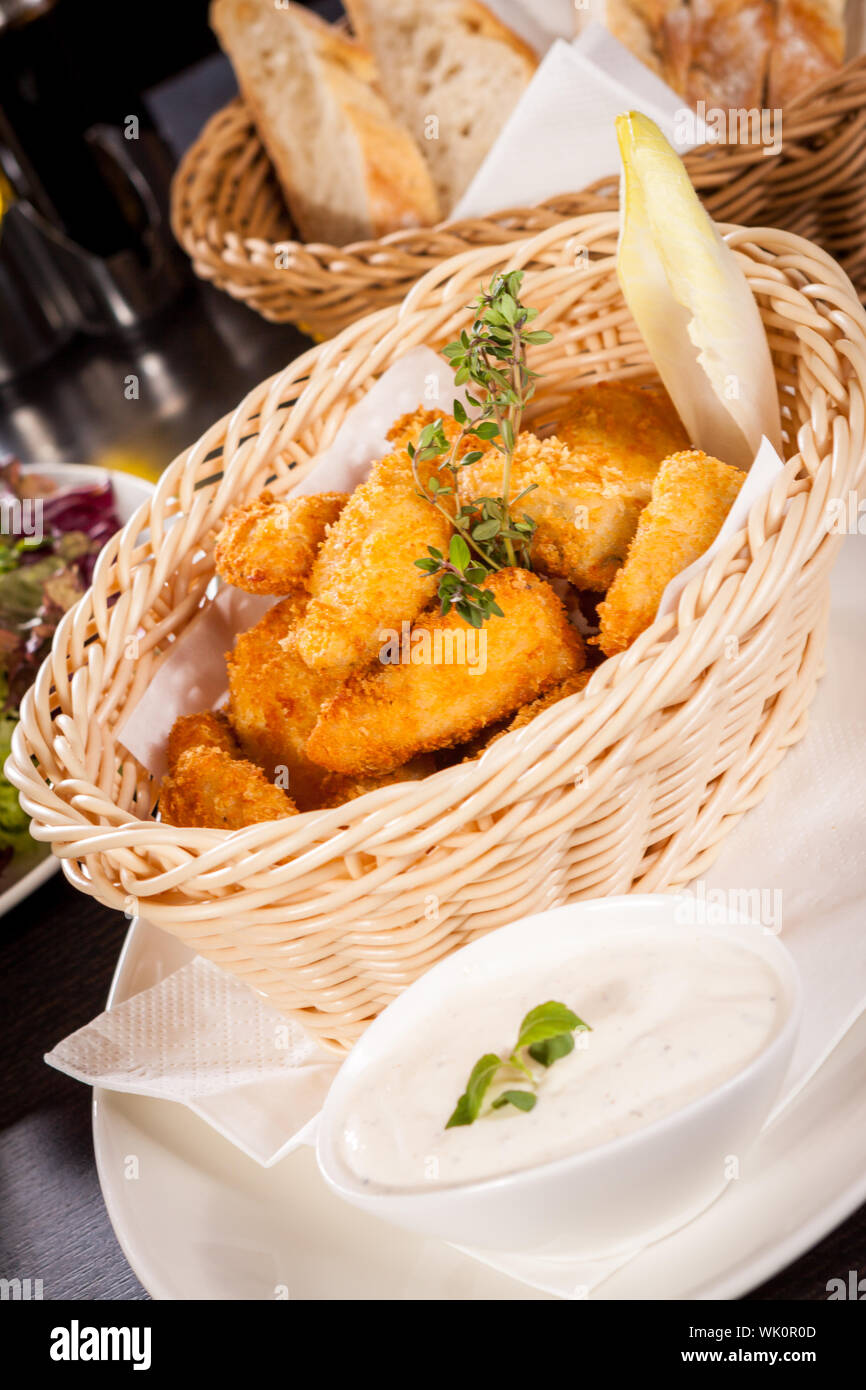 Crumbed chicken nuggets in a basket Stock Photo