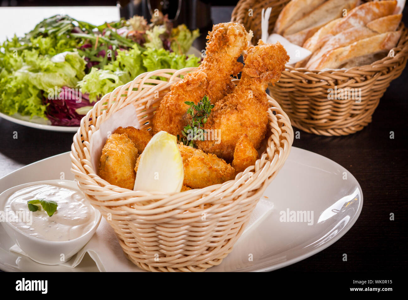Crisp crunchy golden chicken legs and wings deep fried in bread crumbs