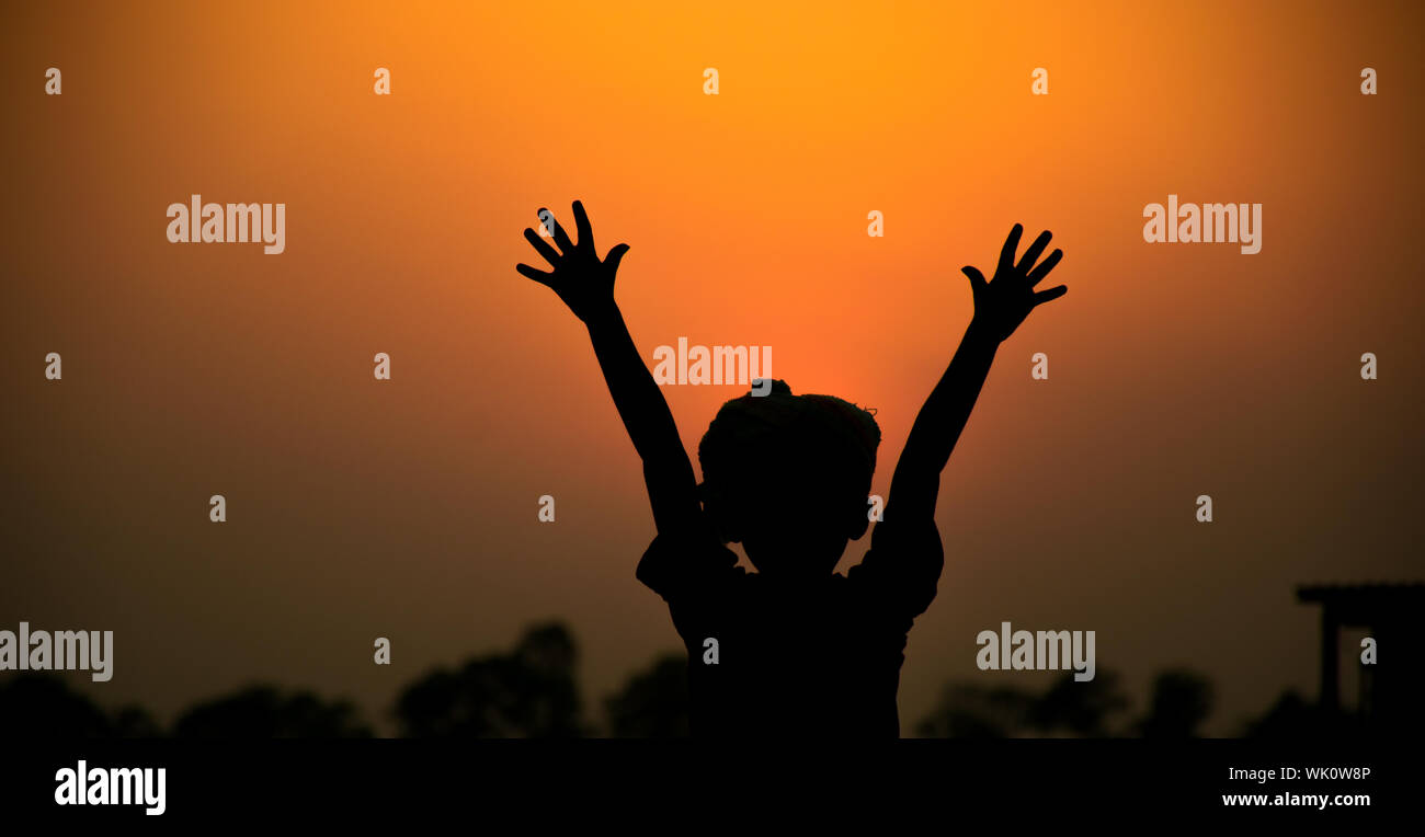 A cute sunset with a young boy shadow. Stock Photo