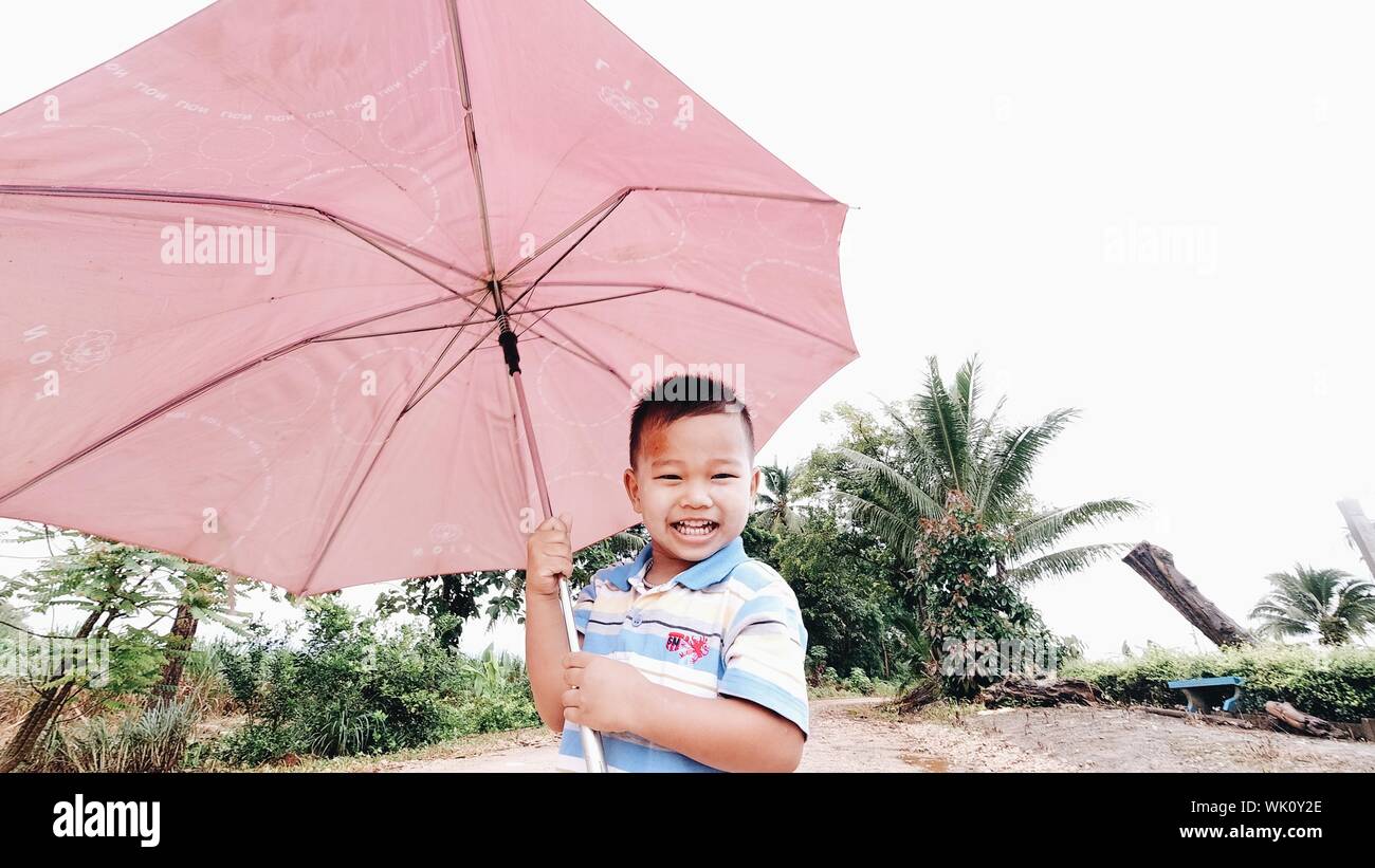 Boy raincoat umbrella hi res stock photography and images Page 2