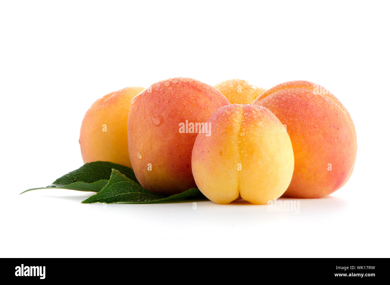 Sweet peaches with leafs on a white background Stock Photo