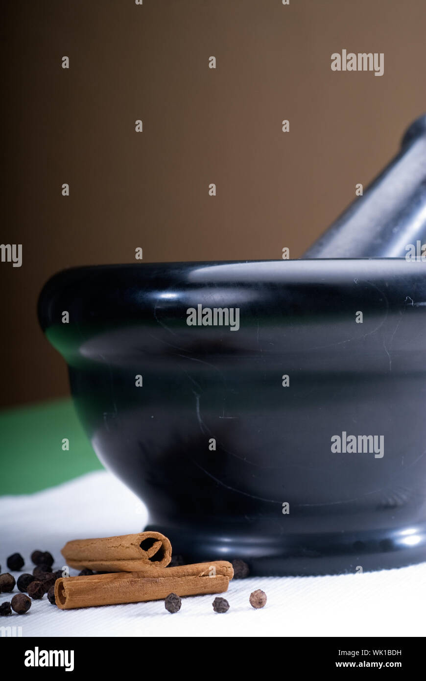 black stone mortar and pestel with cinnamon and pepper Stock Photo Alamy