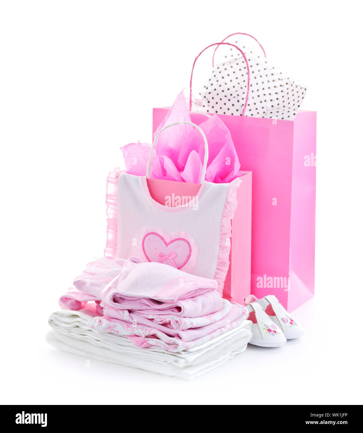Pink gift bags and infant clothes for girl baby shower isolated on