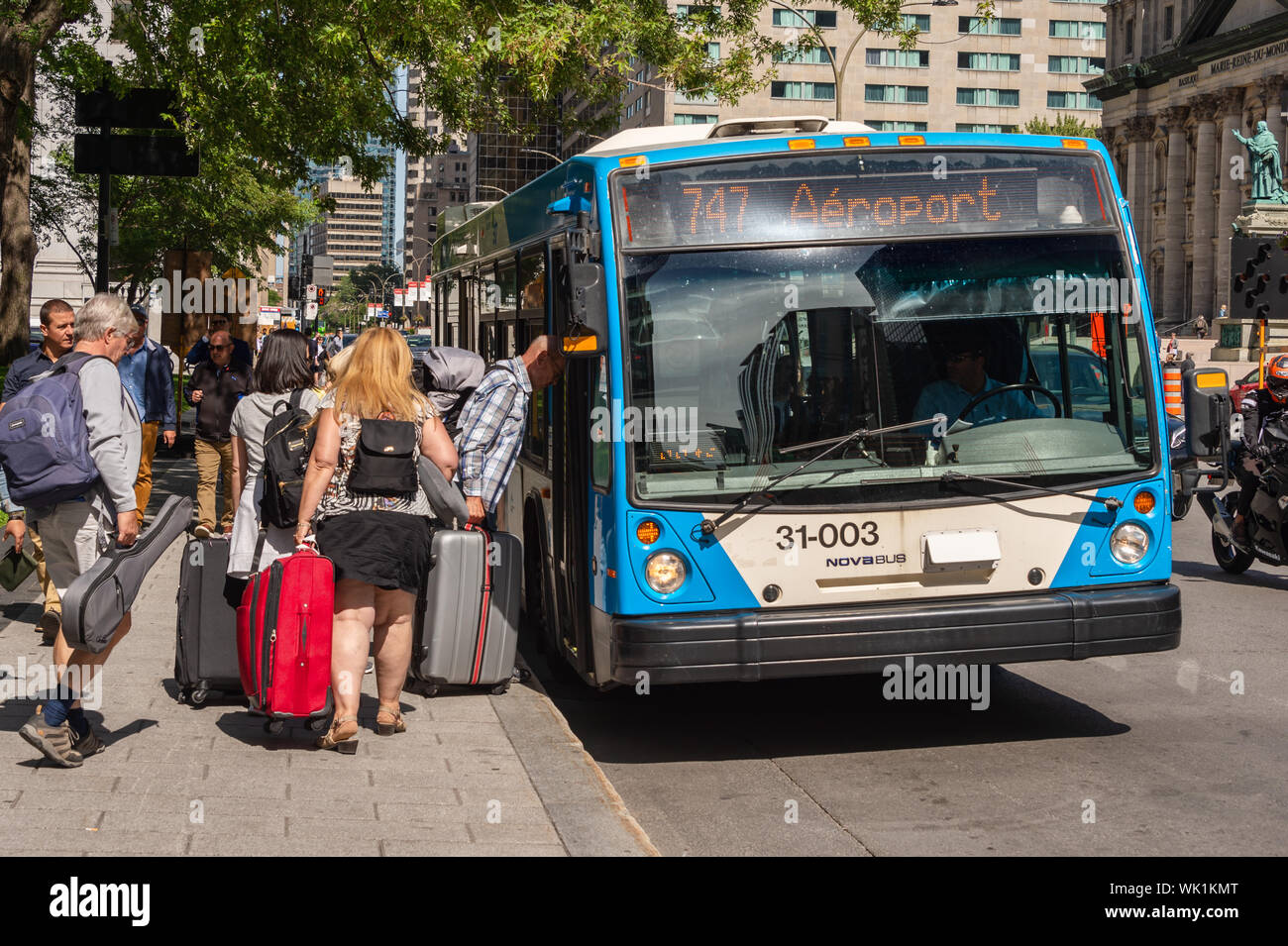 Montreal, CA - 3 September 2019: People boarding the 747 bus going to Montreal Trudeau Airport on René Lévesque Bld. Stock Photo