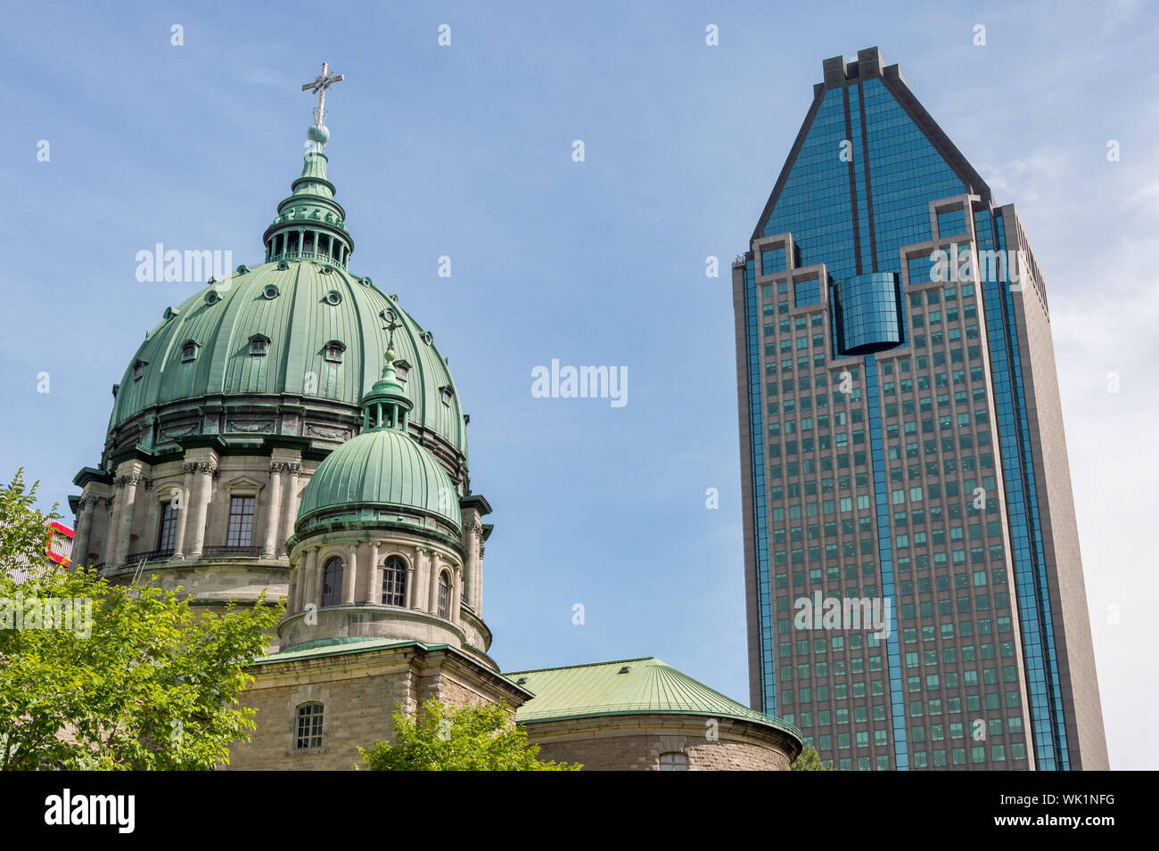 Montreal, Canada - 03 September 2019: La Gauchetiere building & Mary, Queen of the World Cathedral Stock Photo