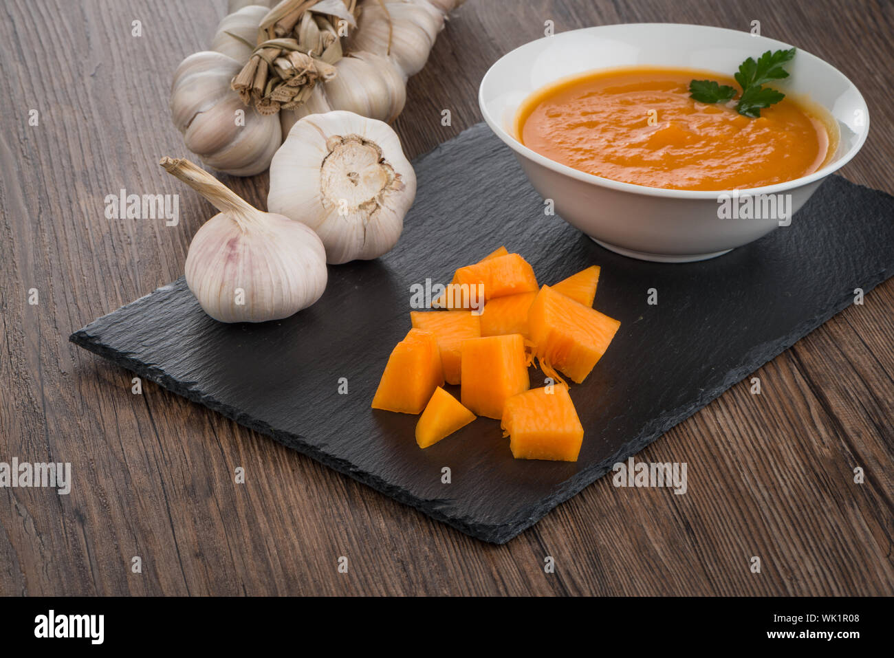 Pumpkin soup on white wood background Stock Photo - Alamy