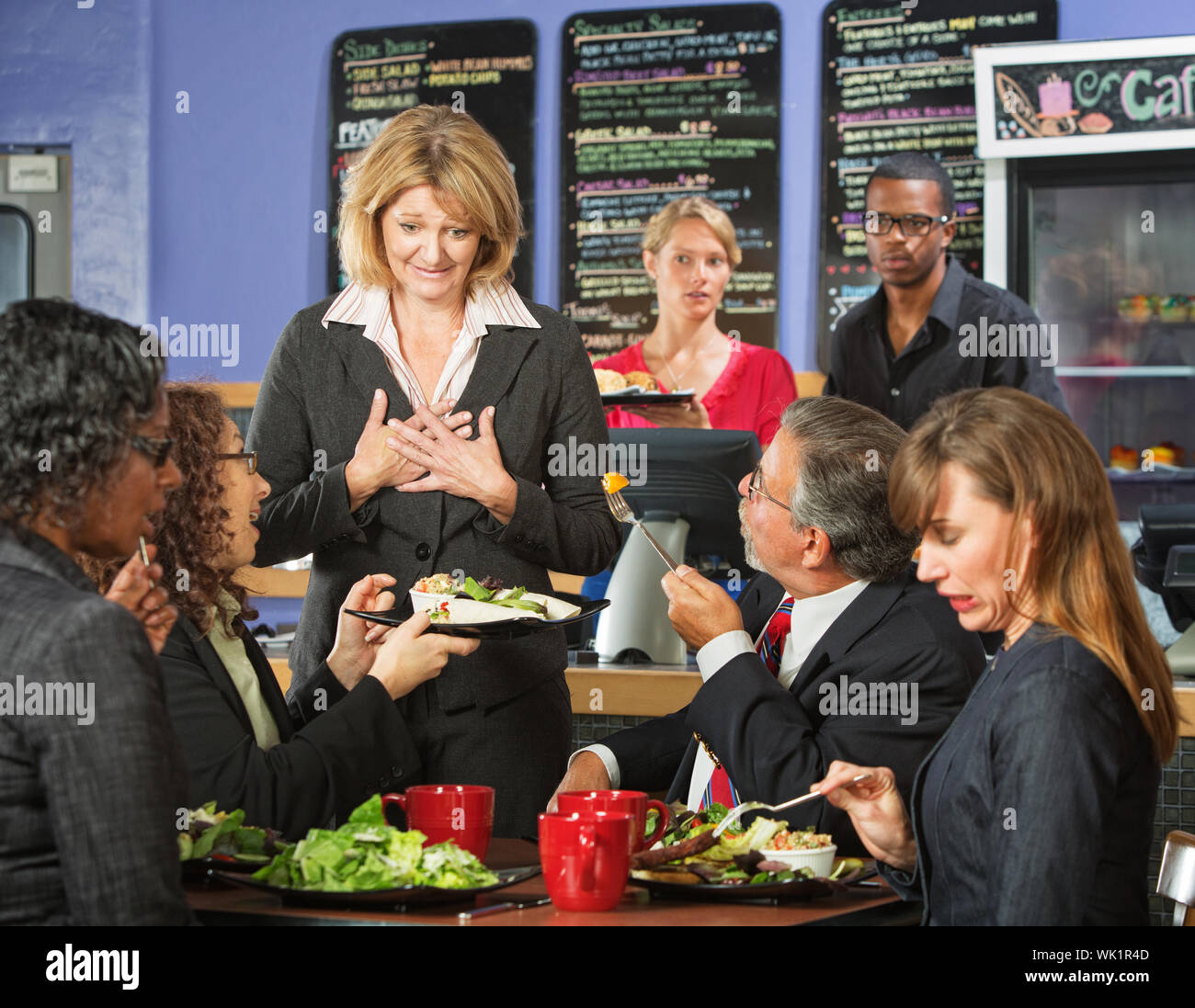 Ashamed coffee house owner with disgusted customers Stock Photo