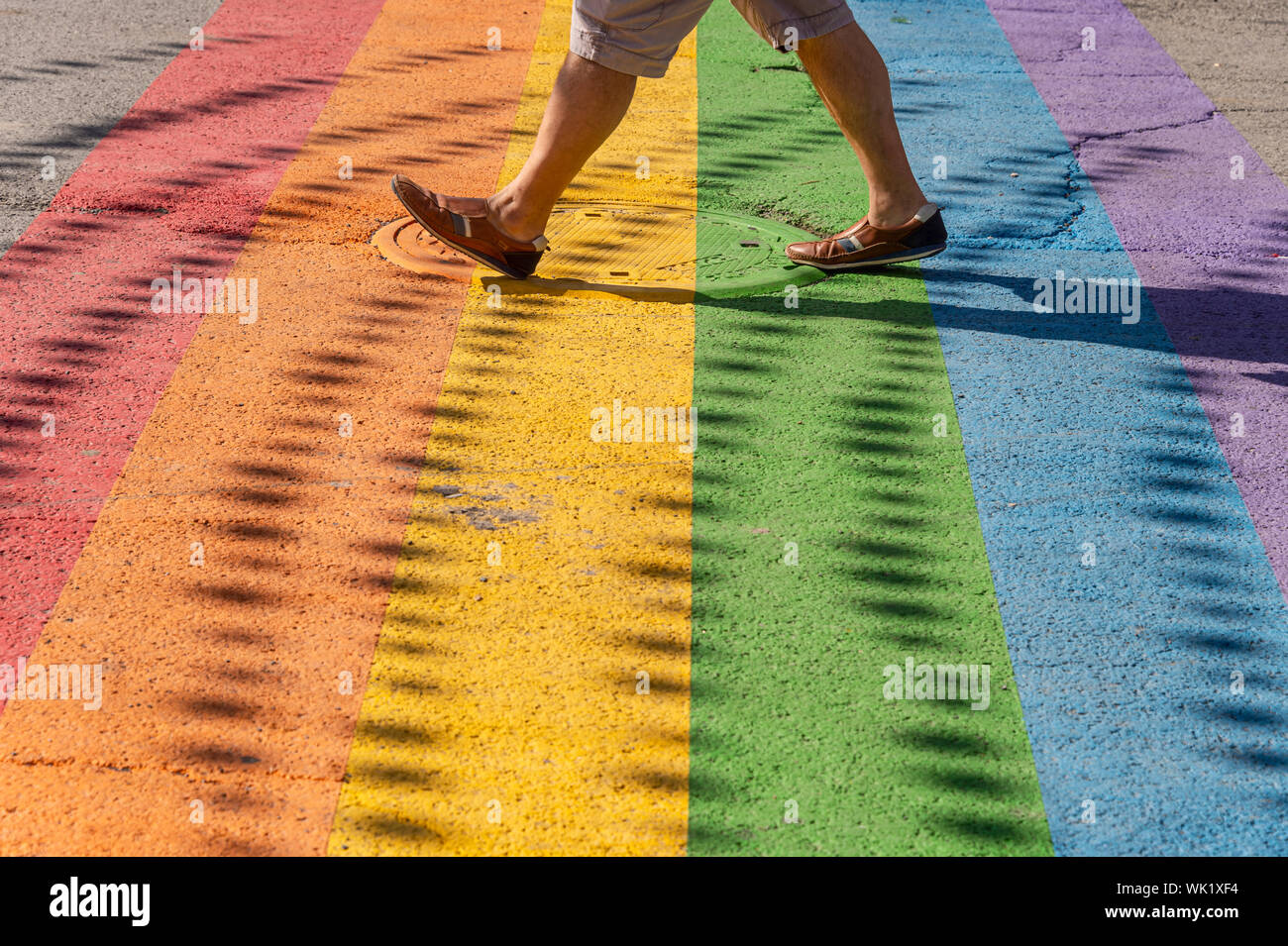 Montreal, Canada - 03 September 2019: Man walking on gay rainbow crosswalk in Montreal gay village Stock Photo