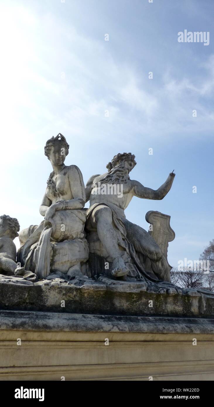 Low Angle View Of Classical Style Sculpture Against Cloudy Sky Stock Photo