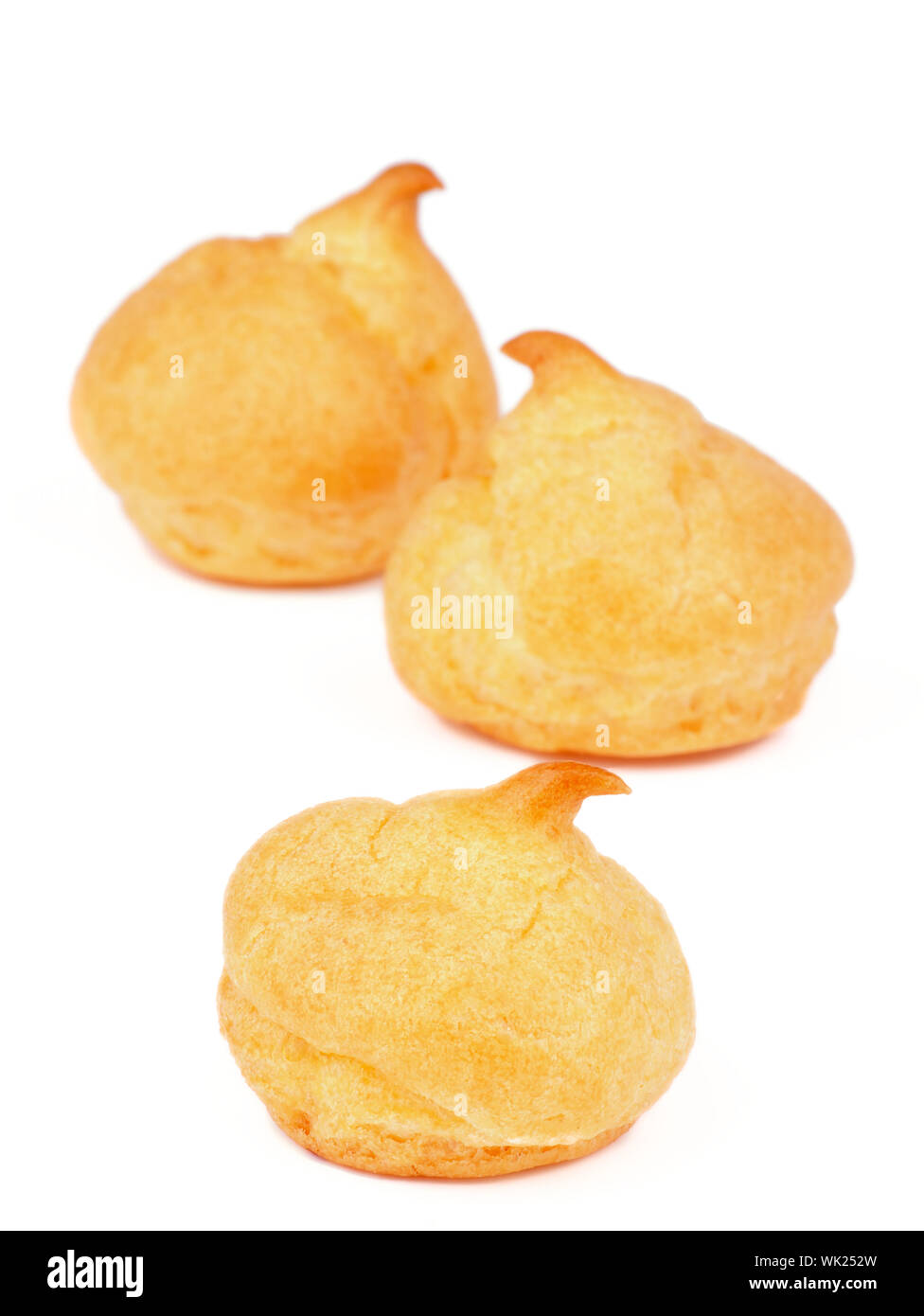 Three Freshly Baked Profiteroles isolated on white background Stock Photo