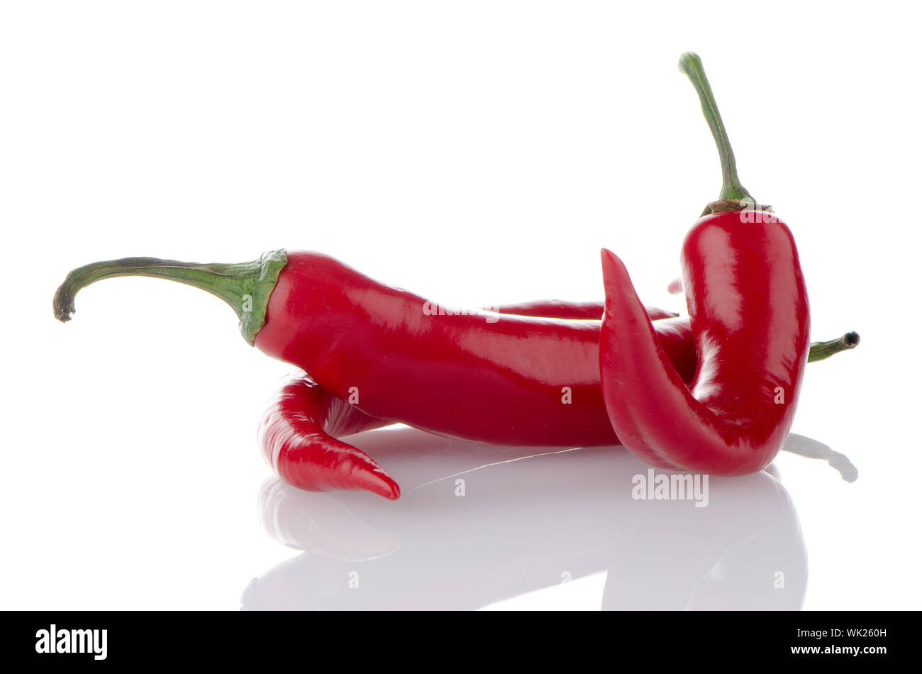 Some red hot peppers on a white background Stock Photo - Alamy